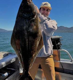 Proudly posing with a massive Halibut catch!